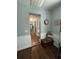 Hallway featuring wood floors, wainscotting, and access to multiple rooms at 1650 Sundance Dr, St Cloud, FL 34771