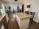 Modern kitchen features a granite island with seating, stainless steel appliances, and a seamless transition to the dining area at 1650 Sundance Dr, St Cloud, FL 34771