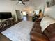 Spacious living room with hardwood floors, ceiling fan, and comfortable leather seating at 1650 Sundance Dr, St Cloud, FL 34771