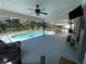 Relaxing screened-in pool area overlooking a peaceful backyard with mature trees and well-maintained landscaping at 1650 Sundance Dr, St Cloud, FL 34771