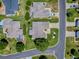 Aerial view of property highlighting the manicured lawn, landscaping, and patterned driveway at 17374 Se 76Th Flintlock Ter, The Villages, FL 32162