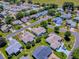 Overhead view of a cozy neighborhood featuring neatly kept lawns and attractive single-Gathering homes at 17374 Se 76Th Flintlock Ter, The Villages, FL 32162