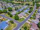 Lovely aerial view of a quiet neighborhood close to a golf course, displaying well-kept yards and charming houses at 17374 Se 76Th Flintlock Ter, The Villages, FL 32162