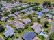 Beautiful aerial view of a home in a well-maintained community with green lawns and mature trees at 17374 Se 76Th Flintlock Ter, The Villages, FL 32162