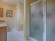 A bright bathroom with modern shower featuring a vanity with cabinet space at 17374 Se 76Th Flintlock Ter, The Villages, FL 32162