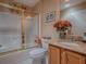 Bathroom featuring a tub, toilet, granite sink, and decor at 17374 Se 76Th Flintlock Ter, The Villages, FL 32162