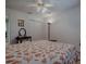 Cozy bedroom with a decorative ceiling fan, closet, and a comfortable bed with a patterned quilt at 17374 Se 76Th Flintlock Ter, The Villages, FL 32162