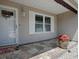 A welcoming front porch with decorative wreath, window, and beautiful stone flooring at 17374 Se 76Th Flintlock Ter, The Villages, FL 32162