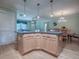 Kitchen island with granite countertops and wooden cabinets at 17374 Se 76Th Flintlock Ter, The Villages, FL 32162
