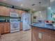Bright kitchen with wooden cabinets, granite countertops, and modern appliances at 17374 Se 76Th Flintlock Ter, The Villages, FL 32162