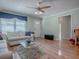 Comfortable living room with hardwood floors, plenty of seating, and a bright, airy feel at 17374 Se 76Th Flintlock Ter, The Villages, FL 32162