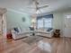 Bright living room with hardwood floors, stylish furnishings, and plenty of natural light at 17374 Se 76Th Flintlock Ter, The Villages, FL 32162