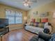 Comfortable living room with cozy seating, and window with view to outside at 17374 Se 76Th Flintlock Ter, The Villages, FL 32162