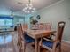 Open-concept view with hardwood floors, living and dining spaces at 17374 Se 76Th Flintlock Ter, The Villages, FL 32162