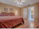 Comfortable main bedroom featuring a ceiling fan and an en suite bathroom entrance at 17374 Se 76Th Flintlock Ter, The Villages, FL 32162
