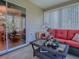 Inviting sunroom with tile flooring, offering comfortable seating, and seamless indoor-outdoor living at 17374 Se 76Th Flintlock Ter, The Villages, FL 32162