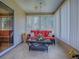 Inviting sunroom with tile flooring, offering an abundance of natural light and comfortable seating at 17374 Se 76Th Flintlock Ter, The Villages, FL 32162