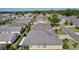 View of a single-story home with a neutral exterior, well-manicured lawn, and mature landscaping within a residential neighborhood at 1754 Pennecamp Dr, The Villages, FL 32162