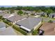 Home featuring a screened lanai with a well-maintained yard, complemented by mature trees and located in a serene community at 1754 Pennecamp Dr, The Villages, FL 32162