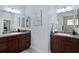 Beautiful dual vanity in the main bathroom with tile floors and granite countertops at 1754 Pennecamp Dr, The Villages, FL 32162
