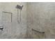 Accessible shower with built-in niche, grab bar, and detailed tile work at 1754 Pennecamp Dr, The Villages, FL 32162