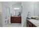 Dual sink vanity with granite countertops and ample storage in the ensuite bathroom at 1754 Pennecamp Dr, The Villages, FL 32162