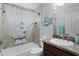 Cozy bathroom with tiled walls, shower-tub, white shower curtain, and vanity sink at 1754 Pennecamp Dr, The Villages, FL 32162