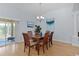 Elegant dining room with a wooden table, chandelier, and sliding glass doors at 1754 Pennecamp Dr, The Villages, FL 32162