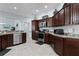 Well-equipped kitchen with stainless steel appliances, granite countertops, and ample cabinet space at 1754 Pennecamp Dr, The Villages, FL 32162