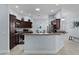 Bright kitchen with wooden cabinets, stone countertop, stainless steel appliances, and eating area at 1754 Pennecamp Dr, The Villages, FL 32162