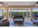Relaxing screened lanai featuring comfortable seating and peaceful backyard views at 1754 Pennecamp Dr, The Villages, FL 32162