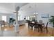 Open-concept living room featuring wood floors, a dining area, and access to an outdoor space at 1754 Pennecamp Dr, The Villages, FL 32162