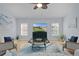 Inviting living room with a ceiling fan, natural light, and stylish decor at 1754 Pennecamp Dr, The Villages, FL 32162
