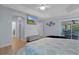 Spacious bedroom with access to the lanai, walk-in closet, and ensuite bathroom at 1754 Pennecamp Dr, The Villages, FL 32162