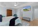 Airy bedroom with a mounted television, an adjacent walk-in closet, and private bathroom at 1754 Pennecamp Dr, The Villages, FL 32162