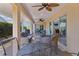 Spacious lanai with ample seating offers a serene outdoor living space, complete with ceiling fans at 1754 Pennecamp Dr, The Villages, FL 32162