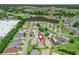 A bird's eye view of the neighborhood showcasing mature landscaping and a beautiful pond at 17787 Se 114Th Ave, Summerfield, FL 34491
