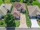 Birds eye view of home showcasing the surrounding landscaping, neighbor's homes, and roof at 17787 Se 114Th Ave, Summerfield, FL 34491