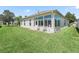 Well-maintained backyard showing a large grassy area and enclosed lanai at 17787 Se 114Th Ave, Summerfield, FL 34491