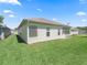 Spacious backyard showing an enclosed lanai and manicured lawn at 17787 Se 114Th Ave, Summerfield, FL 34491