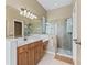 Bathroom featuring walk-in shower, vanity with sink, and vanity with space for seating at 17787 Se 114Th Ave, Summerfield, FL 34491