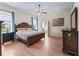 Inviting bedroom with hardwood floors, ceiling fan, and natural light at 17787 Se 114Th Ave, Summerfield, FL 34491