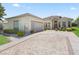 Attractive exterior with decorative brick driveway and beautiful landscaping at 17787 Se 114Th Ave, Summerfield, FL 34491
