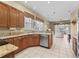 Kitchen area featuring stainless appliances, granite countertops, and oak cabinets at 17787 Se 114Th Ave, Summerfield, FL 34491