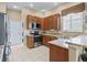 Kitchen with oak cabinets, granite countertops, and stainless steel appliances at 17787 Se 114Th Ave, Summerfield, FL 34491