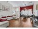 Bright living room and dining area featuring wood laminate floors and large windows at 17787 Se 114Th Ave, Summerfield, FL 34491