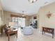 Living room with tile flooring, a ceiling fan, and access to the sunroom at 17787 Se 114Th Ave, Summerfield, FL 34491