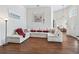 Spacious living room featuring a large sectional sofa and wood laminate flooring at 17787 Se 114Th Ave, Summerfield, FL 34491