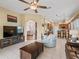 Bright living room featuring a ceiling fan, arched doorway, and tiled floors at 17787 Se 114Th Ave, Summerfield, FL 34491