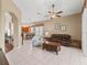 Spacious living room featuring tile floors, ceiling fan, and furniture at 17787 Se 114Th Ave, Summerfield, FL 34491